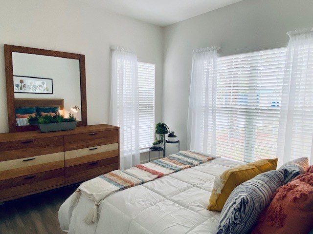 bedroom with a bed and a mirror at Mainstreet Apartments, Clearwater, FL